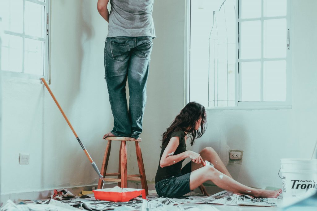 a couple painting the walls of their home