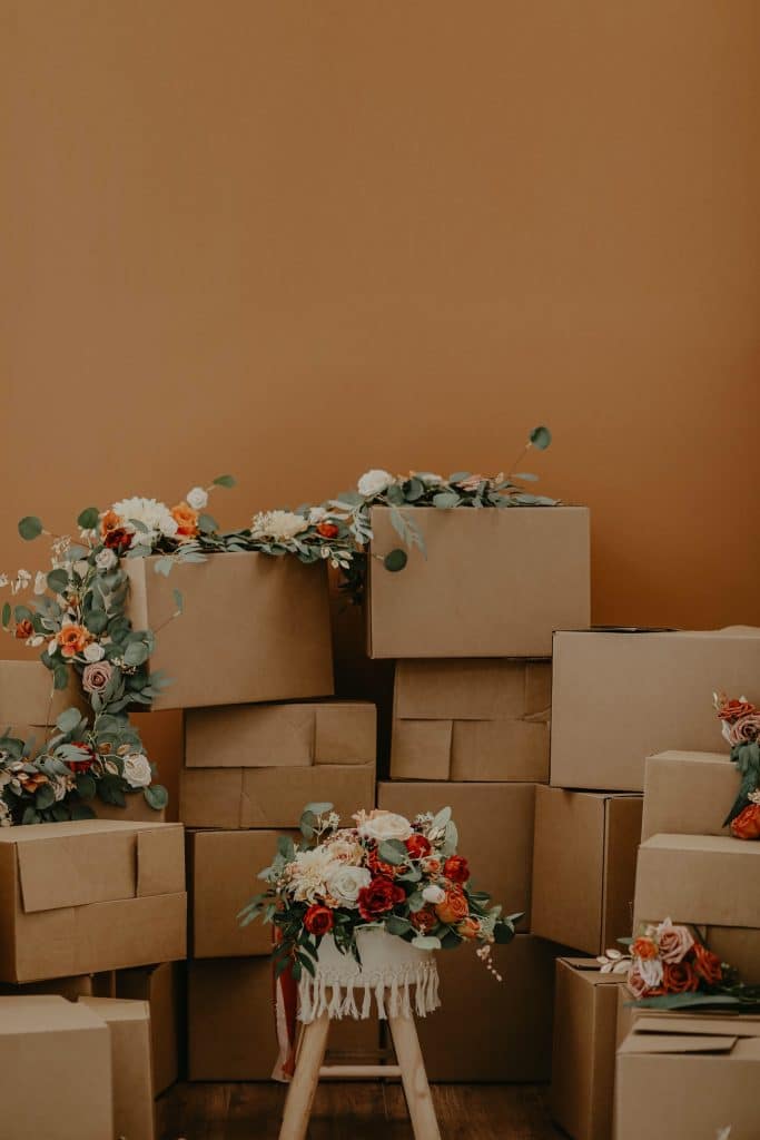 stacked cardboard packing boxes with flower decorations